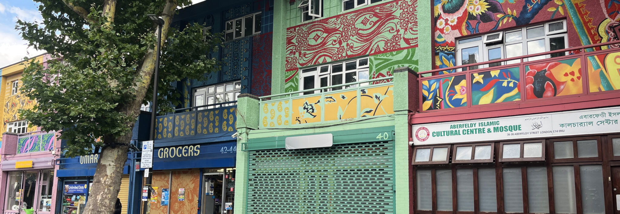 Photograph of some premises in Poplar painted with bright colours and patterns.